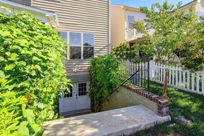A residential building with a front door, windows, and a white picket fence. - Ashburn Extended Stay w/ Shared Yard (Ashburn)