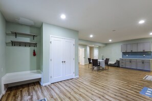 A spacious kitchen with modern cabinetry and a dining area with a table and chairs. - Ashburn Extended Stay w/ Shared Yard (Ashburn)