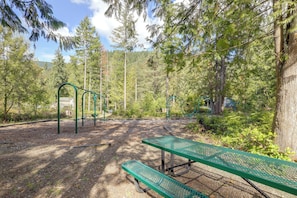 A park with green metal benches and exercise equipment. - Hike, Ski & Soak! Mt. Hood Getaway w/ Hot Tub (Rhododendron)