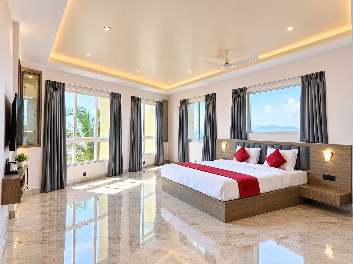 A modern hotel room with a large bed, a flat-screen TV, and a view of the outdoors.