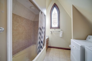 A bathroom with a shower, a window with stained glass, and a washing machine. - 6 Mi to Dtwn! Historic Haven in Cleveland (Cleveland)