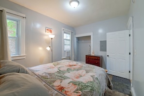 A bedroom with a bed, a dresser, a wardrobe, and a window with curtains. - Spacious Troy Unit Near Dtwn Shops & Dining (Troy)