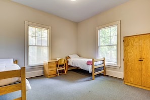 A bedroom with two beds, a desk, and a wardrobe. - Walk to Decatur Square! Spacious Home w/ Porch (Decatur)