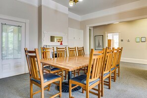 A conference room with a large wooden table surrounded by chairs, a whiteboard, and a mirror on the wall. - Walk to Decatur Square! Spacious Home w/ Porch (Decatur)