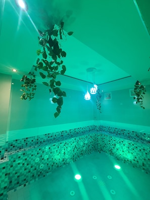 A room with a tiled floor, hanging plants, and pendant lights. - Quiet Pols Residence  (Lagos)