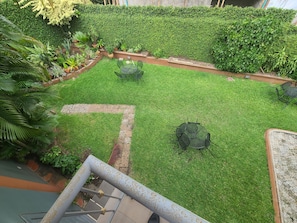 A well-maintained garden with a lawn, potted plants, and outdoor furniture. - Quiet Pols Residence (Lagos)