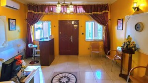 A hotel lobby with a reception desk, a clock, and a door marked 'EXIT'. - Quiet Pols Residence  (Lagos)