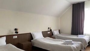 A hotel room with two single beds, a nightstand, a lamp, and a window with curtains. - Mirano Guest House Hostel  (Karakol town)