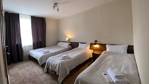 A hotel room with three single beds, a ceiling fan, and a window with curtains. - Mirano Guest House Hostel  (Karakol town)