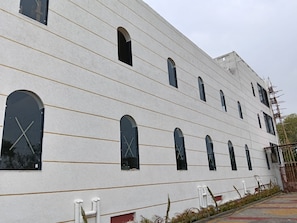 A building with multiple arched windows and a plain facade.