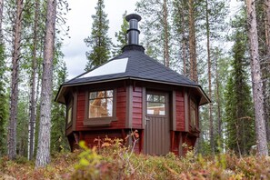 A small cabin with a chimney, surrounded by a forest. - SointuiLevi Premium A43 by Holiday in Lapland (Levi)