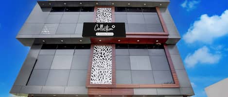 A modern building with a sign that reads 'Collection Company-Serviced'.