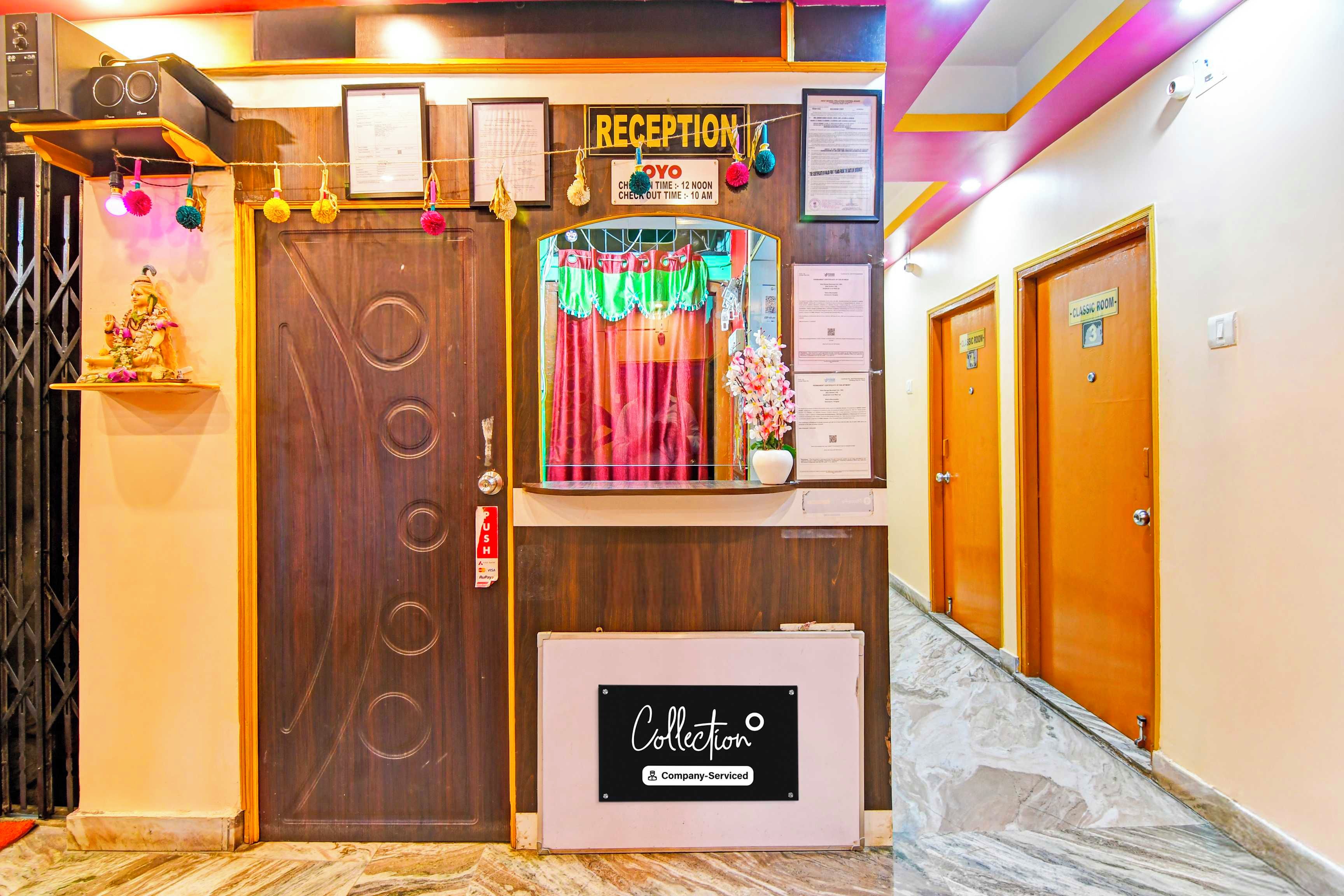 A reception area with a wooden door, a reception desk, and a sign indicating 'Reception'.