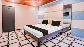 A modern bedroom with a bed, a ceiling fan, and a door. - Collection O Khoni Taloja Bypass (Mumbai)