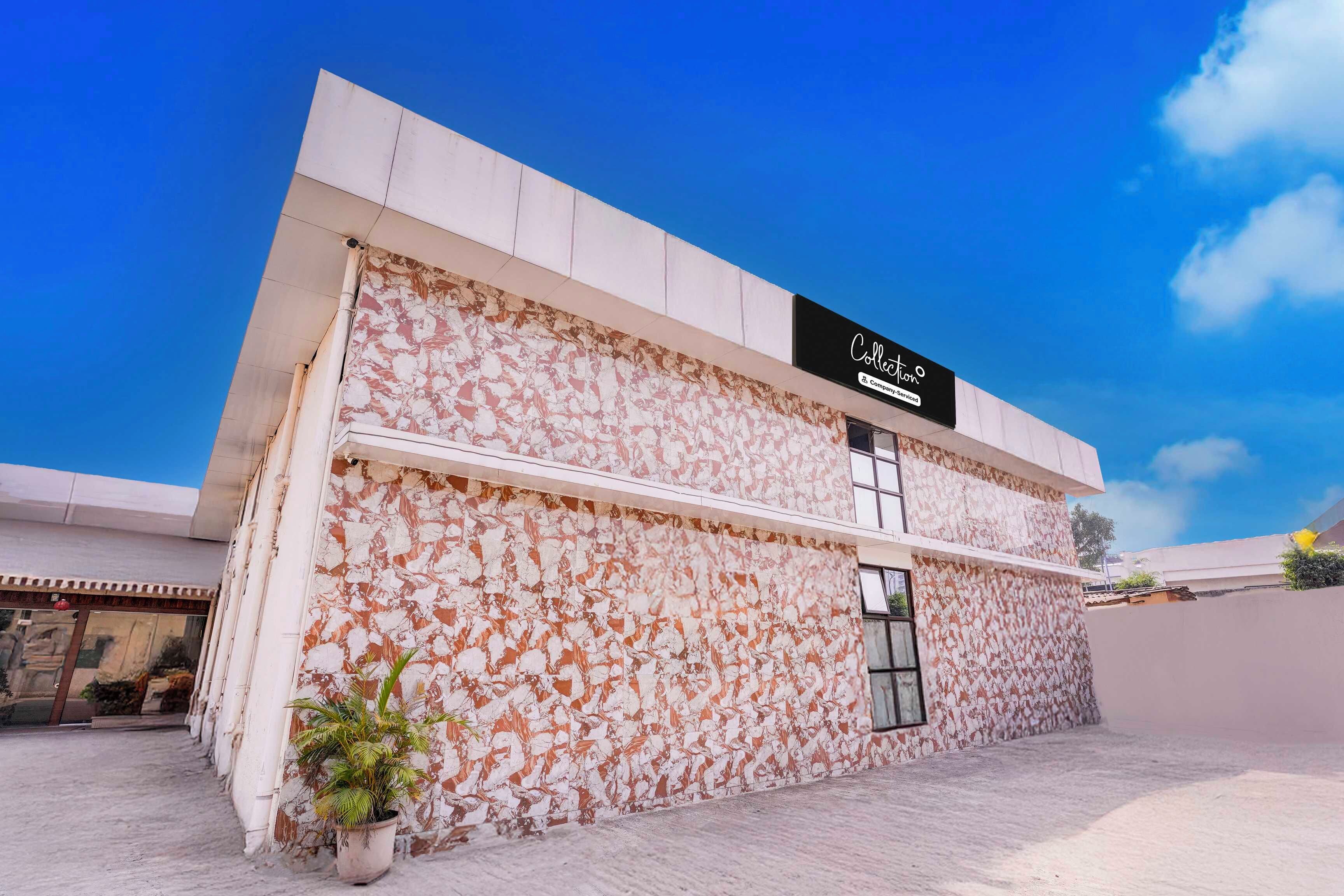 A building with a distinctive marbled facade and a sign that reads 'Collection Company Services'.