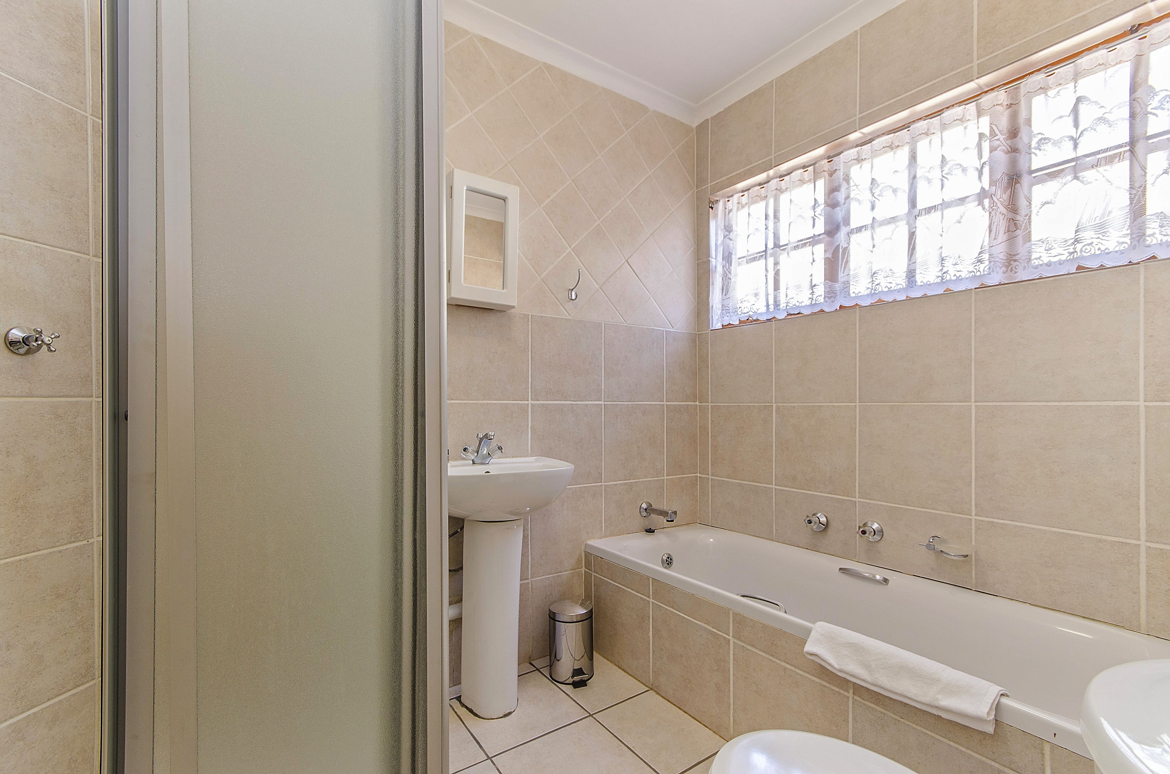 A bathroom with a bathtub, a sink, and a toilet.