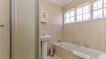 A bathroom with a bathtub, a sink, and a toilet.
