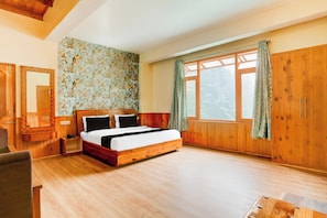 A wooden-paneled bedroom with a bed, a nightstand, a mirror, and a window with curtains. - Hotel O Model Town Road (Manali)