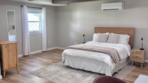 A bedroom with a bed, bedside tables, a desk, and a chair. - Wonderful 3-bedroom house in Fort Wayne perfect for your getaway near downtown (Fort Wayne)