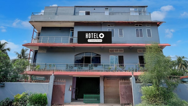 A multi-story hotel with a prominent 'HOTEL' sign, a gated entrance, and a balcony on the upper floor. - Hotel O Garchuk Market (Guwahati)