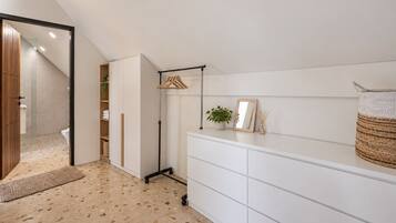 A modern bathroom with a shower, a toilet, and a vanity with a mirror.
