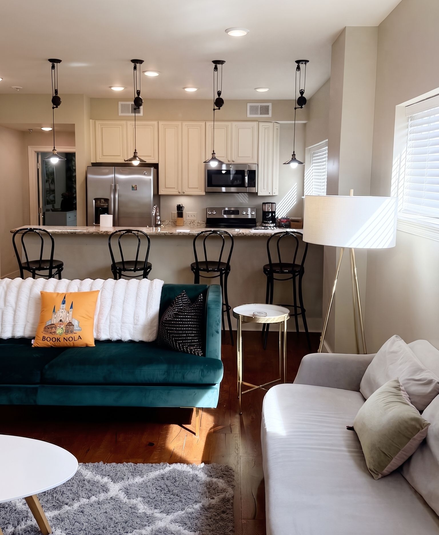 A modern living room with a sofa, a coffee table, and a lamp.