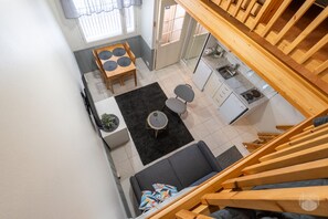 A compact living space with a dining area, kitchen, and a staircase. - Postintie 1608 by Holiday in Lapland (Levi)