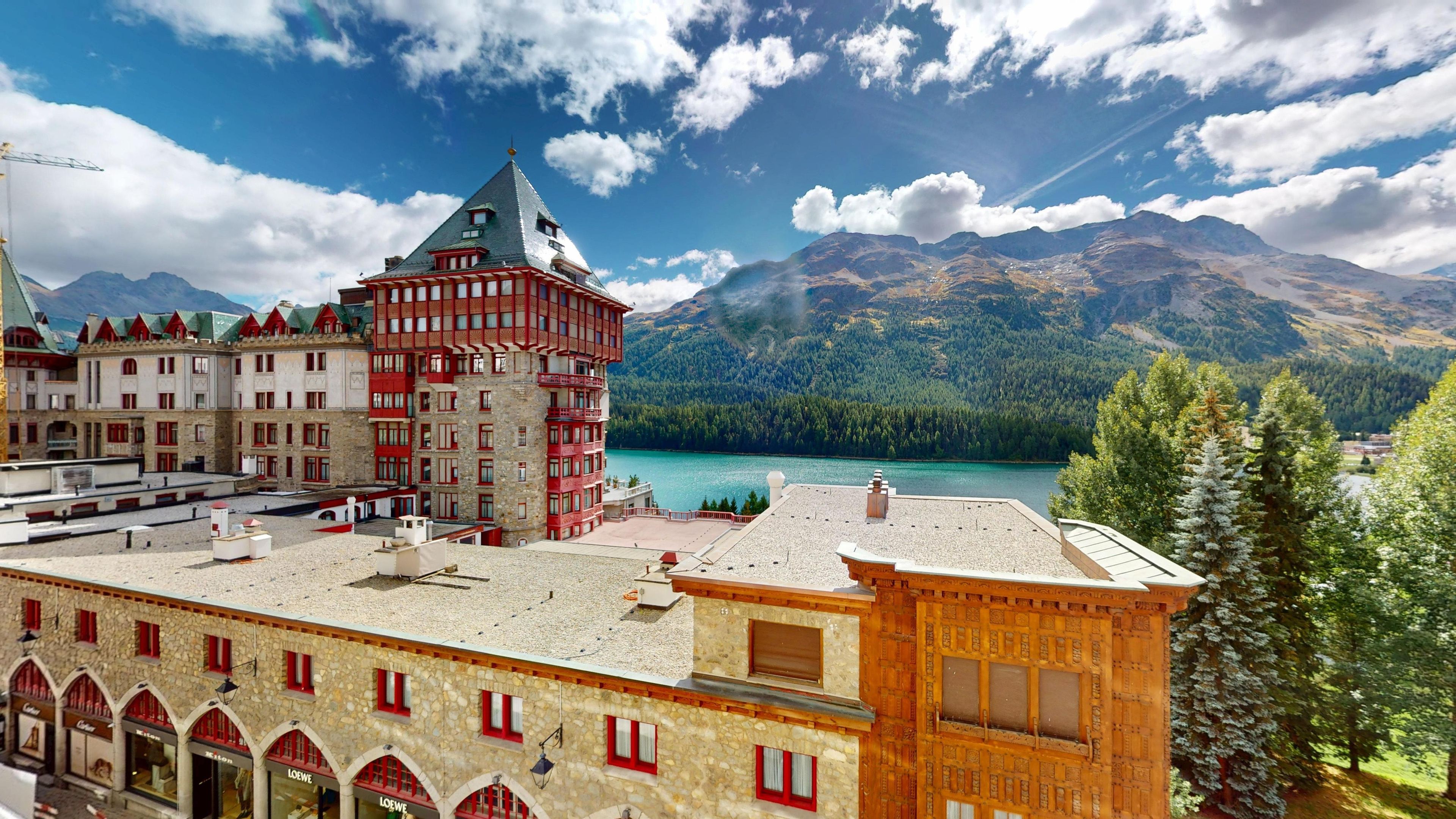 A hotel with a traditional architectural style, featuring a prominent tower and multiple windows.