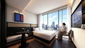 A modern hotel room with a large bed, a seating area, a small table, and a city view. - Ruilan (Guangzhou)