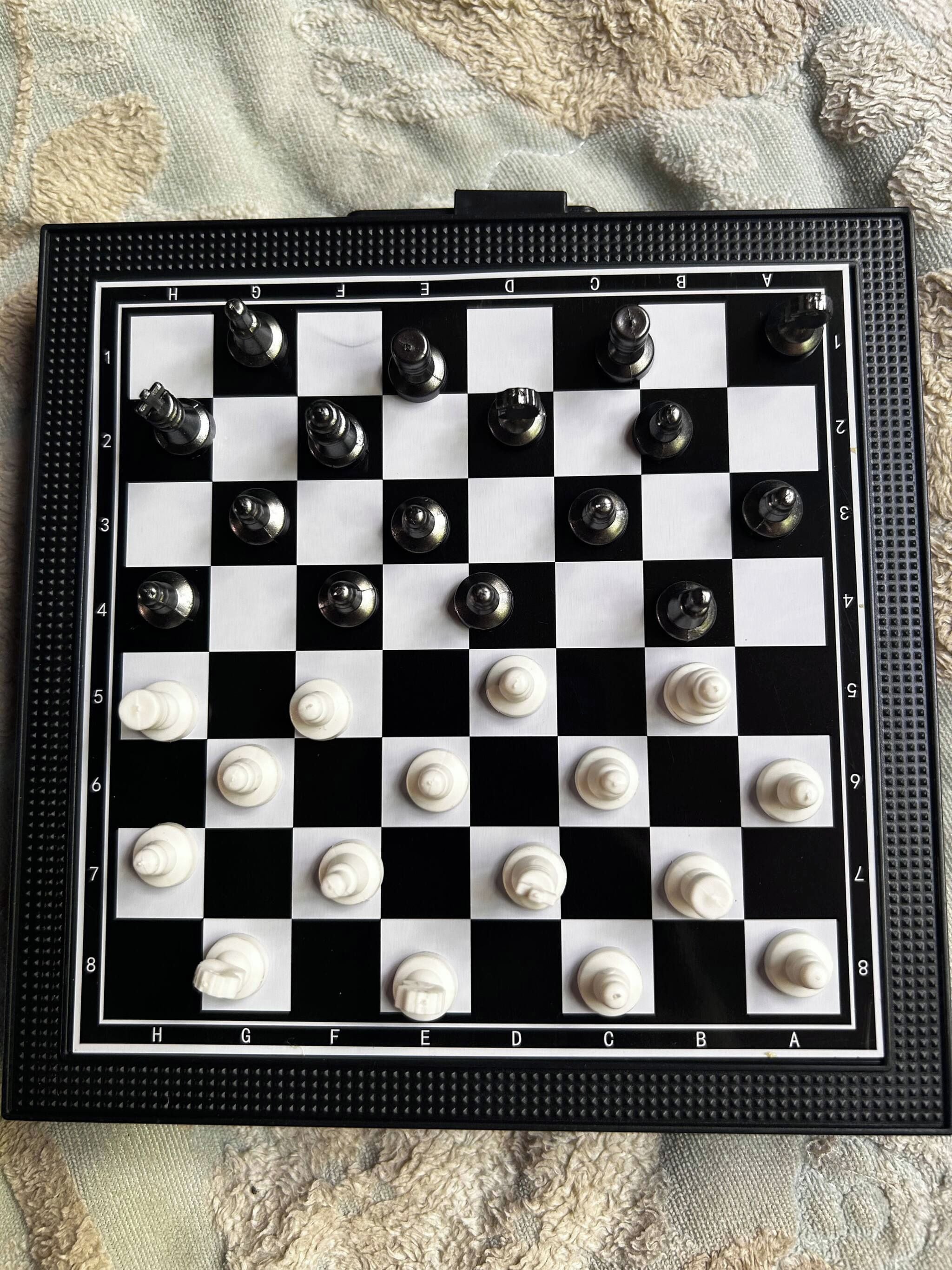 A chessboard with pieces in a starting position.