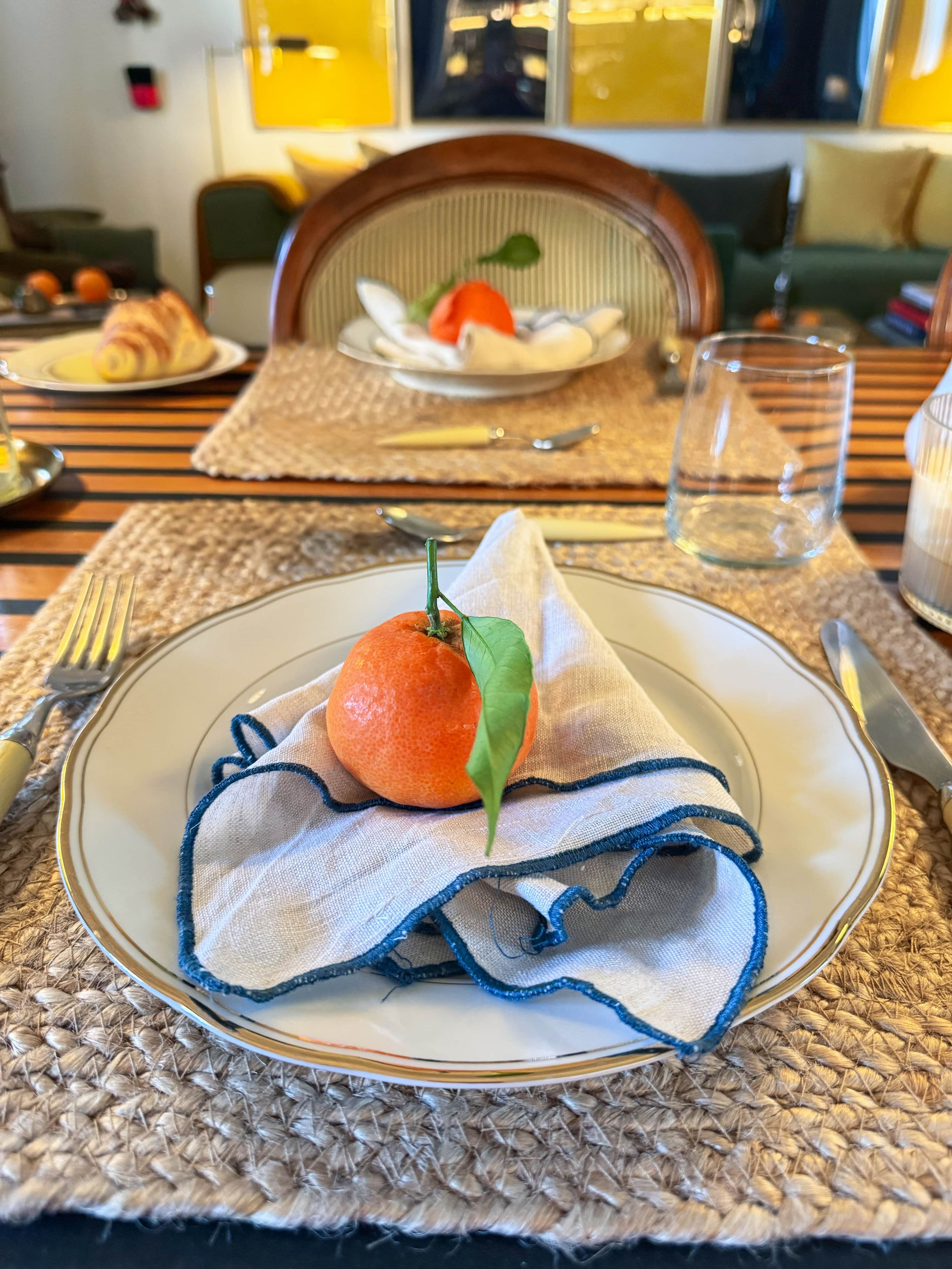 A dining table with a plate of food, a napkin, and cutlery.