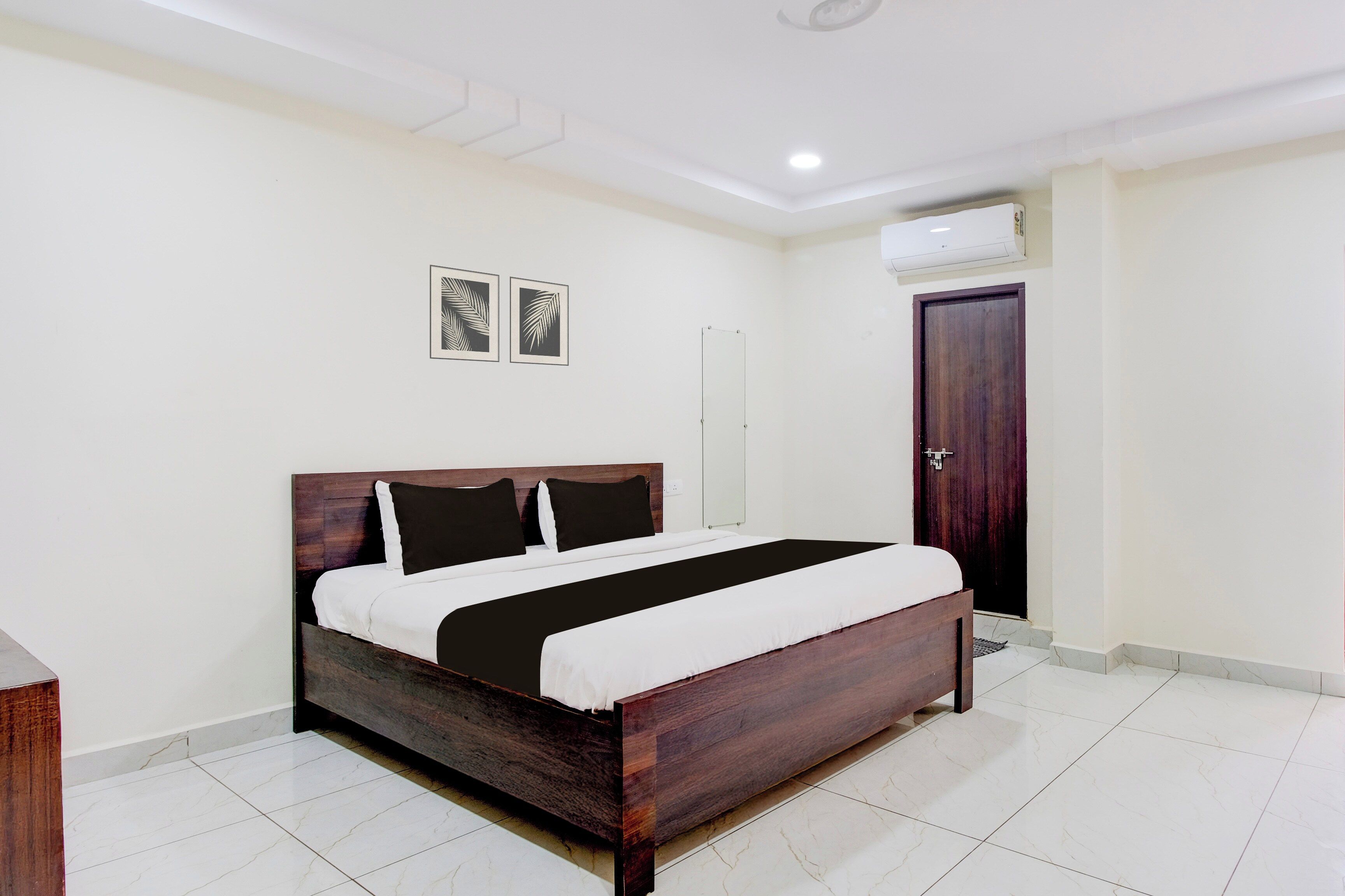 A bedroom with a wooden bed, white walls, and a tiled floor.