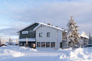 A two-story hotel with a sign indicating it is a hotel and apartments. - Sivulantie 4 207 by Holiday in Lapland (Äkäslompolo)