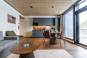 A modern interior with a dining area, kitchen, and seating space. - Metsonlinna 205 by Holiday in Lapland (Levi)