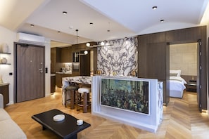 A modern hotel room with a marble accent wall, a dining area with bar stools, a large painting, and a separate bedroom with a bed and headboard. - Acropolis Luxury Penthouse with Private Jacuzzi, Apartment (Athens)