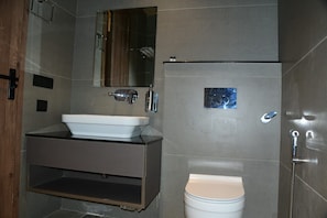 A modern bathroom with a white sink, mirror, and toilet. - INDUS VALLEY (Bulandshahr)