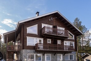 A multi-story wooden building with balconies and large windows. - SanAlppi 7 by Holiday in Lapland (Levi)