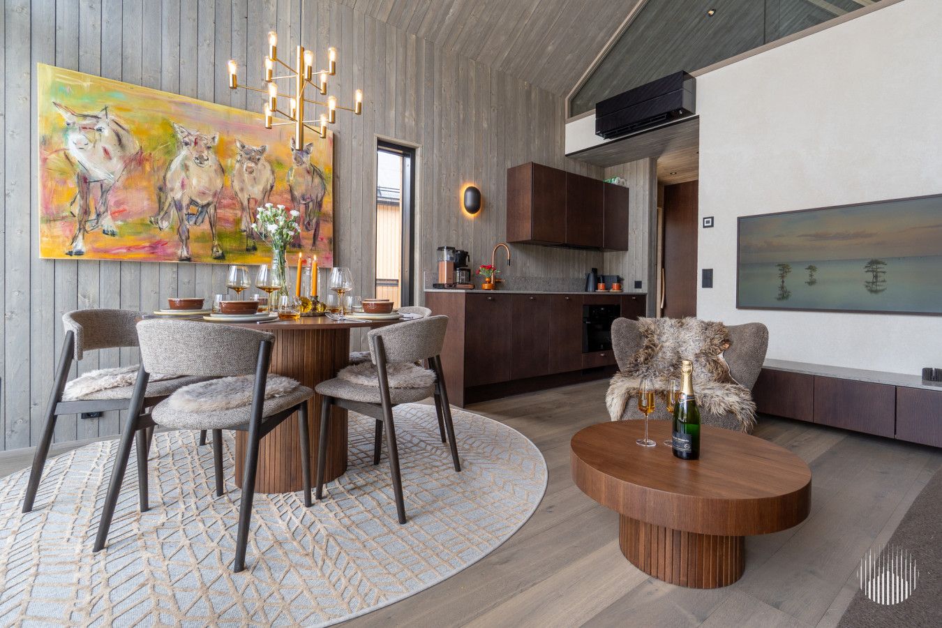 A modern interior with a dining area, a sofa, and a large abstract painting.