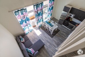A modern interior with a dining area, kitchen, and seating space.