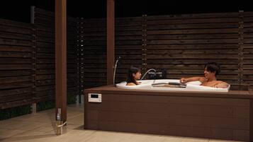 An outdoor hot tub with two people.