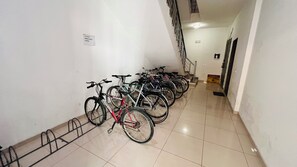 A row of bicycles parked against a wall in a hallway with a tiled floor. - Family apartment in Shkoder: balcony, work corner, free parking (Shkodër)