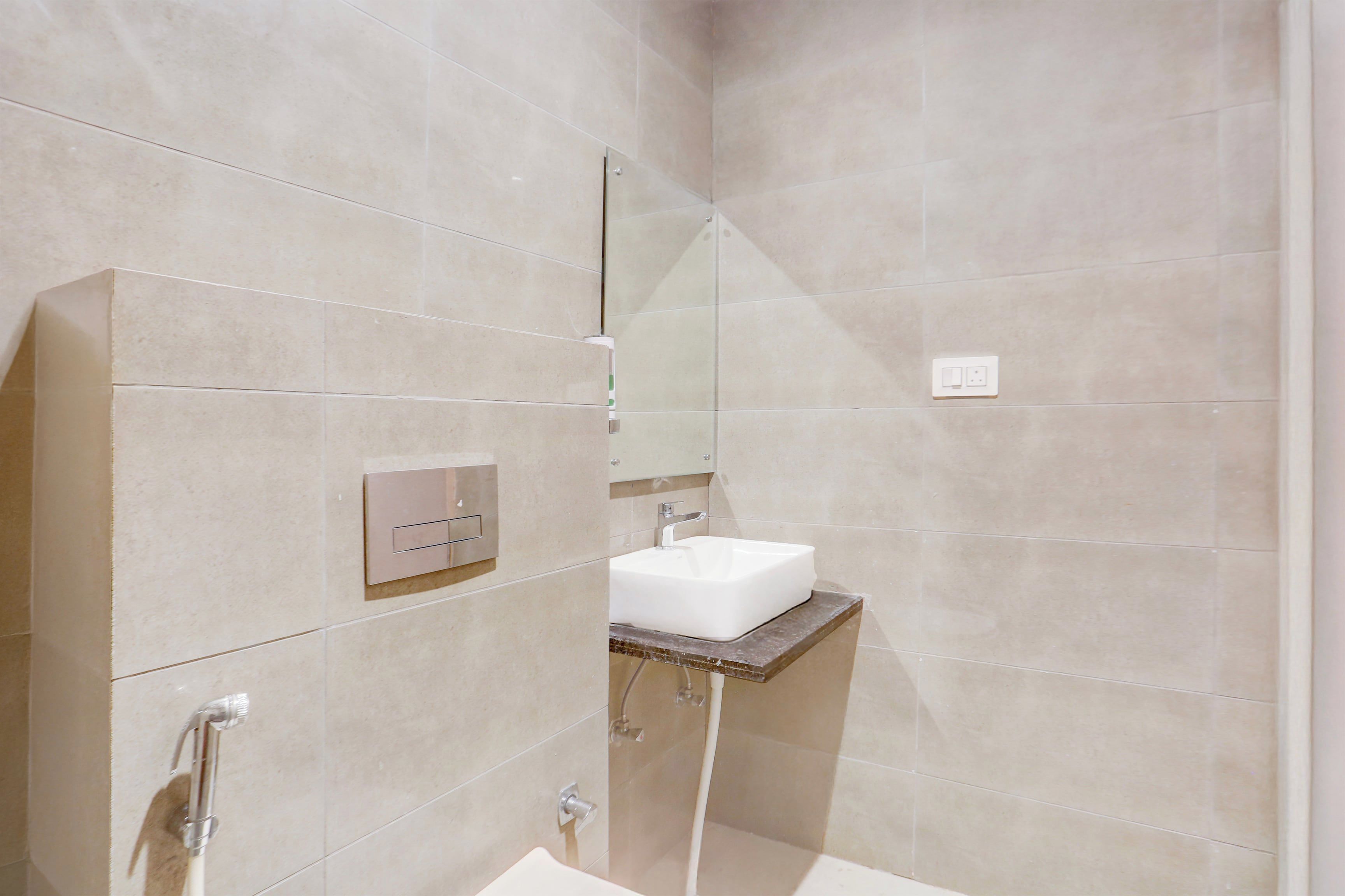 A modern bathroom with a shower, a sink, and a mirror.