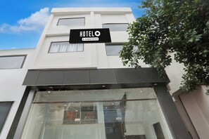 A hotel sign with the name 'HOTELO' and a 'Company-Serviced' label.
