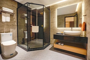 A modern bathroom with a glass-enclosed shower, a white toilet, a sink with a mirror, and a towel rack. - YueSton CinemaAdesig Hotel (Guangzhou)
