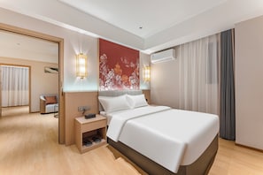 A hotel room with a bed, bedside tables, an air conditioning unit, and a view of the adjacent room. - YueSton CinemaAdesig Hotel (Guangzhou)