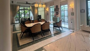 A spacious dining area with a marble countertop, a ceiling fan, and a view of the outdoors. - M Signature Tropical Villas Phu Quoc (Phu Quoc)