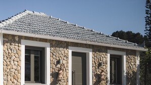 A stone house with a tiled roof, a pool, and a stone staircase leading to the entrance. - Binios Villa - private pool, walking distance from the Beach (Ano Vasilikos)