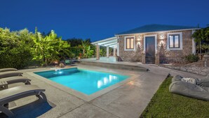 A residential property with a swimming pool, stone exterior, and a covered patio area. - Binios Villa - private pool, walking distance from the Beach (Ano Vasilikos)