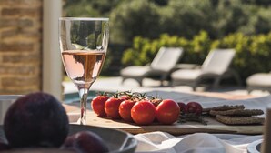 A table with a glass of white wine, tomatoes, and bread on a terrace with a mountain view. - Binios Villa - private pool, walking distance from the Beach (Ano Vasilikos)