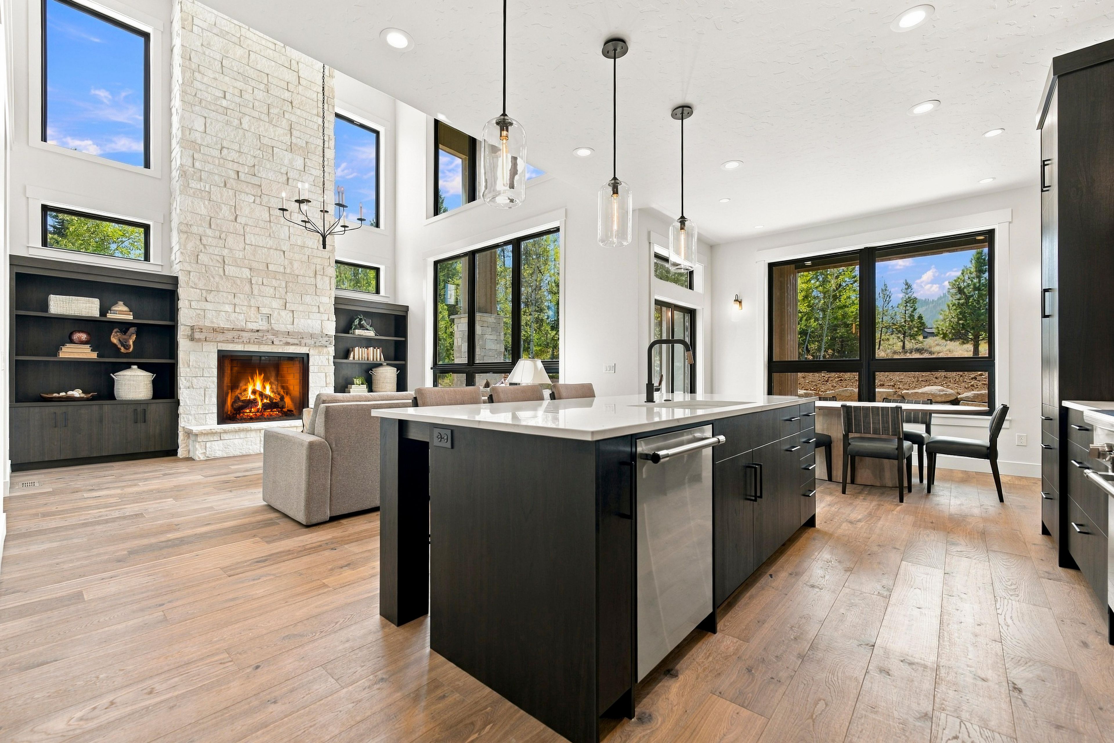 A modern kitchen with a central island, built-in appliances, and a fireplace.